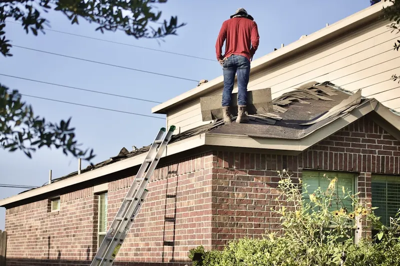Professional roofer working on a residential roof in Chehalem